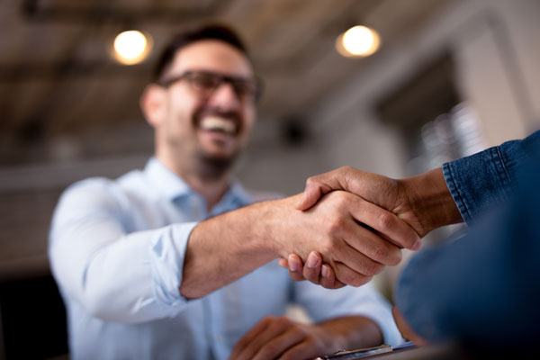 Men shaking hands after a deal with a cash home buyer